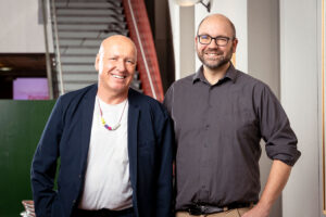 The Organoid Intelligence project’s WSE PI, Thomas Hartung, Ph.D., M.D., and APL PI, Erik Johnson, Ph.D., stand beside each other. Team member names – including those not pictured – are listed in the text below the image.
