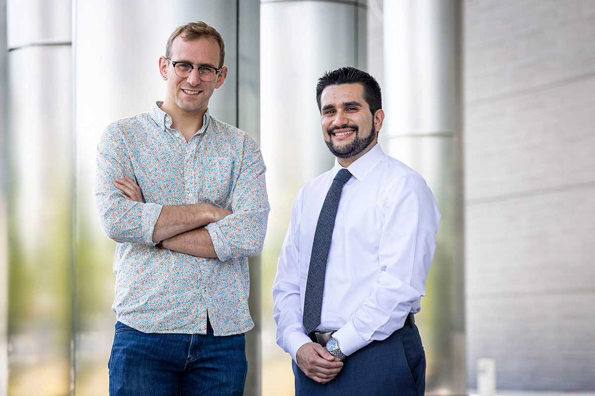 ADD-H2 PIs APL PI Avi Bregman, Ph.D., and WSE PI Corey Oses, Ph.D. stand beside each other outside of a building on APL's campus.