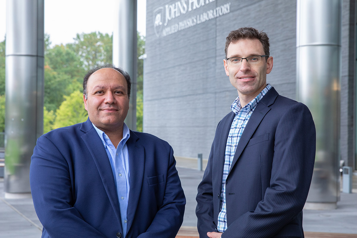 PARS PIs WSE PI Emad Boctor, Ph.D., and APL PI Seth Billings, Ph.D. stand beside each other on APL's campus.